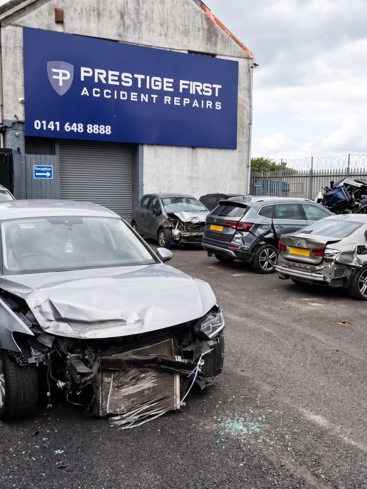 Accident damaged vehicles awaiting car body repairs at Prestige First in Glasgow